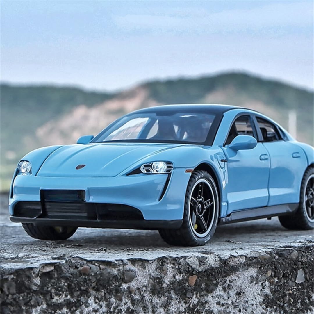 Blue sports car on a rocky surface with a mountainous background